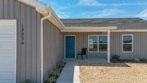 Modern front door entrance with a clear sky and welcoming design at house number 13934.
