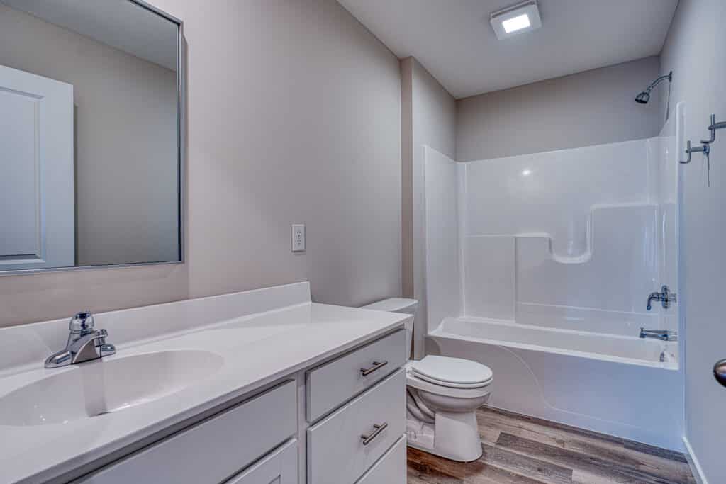 Modern minimalist bathroom featuring sleek fixtures and a clean design.