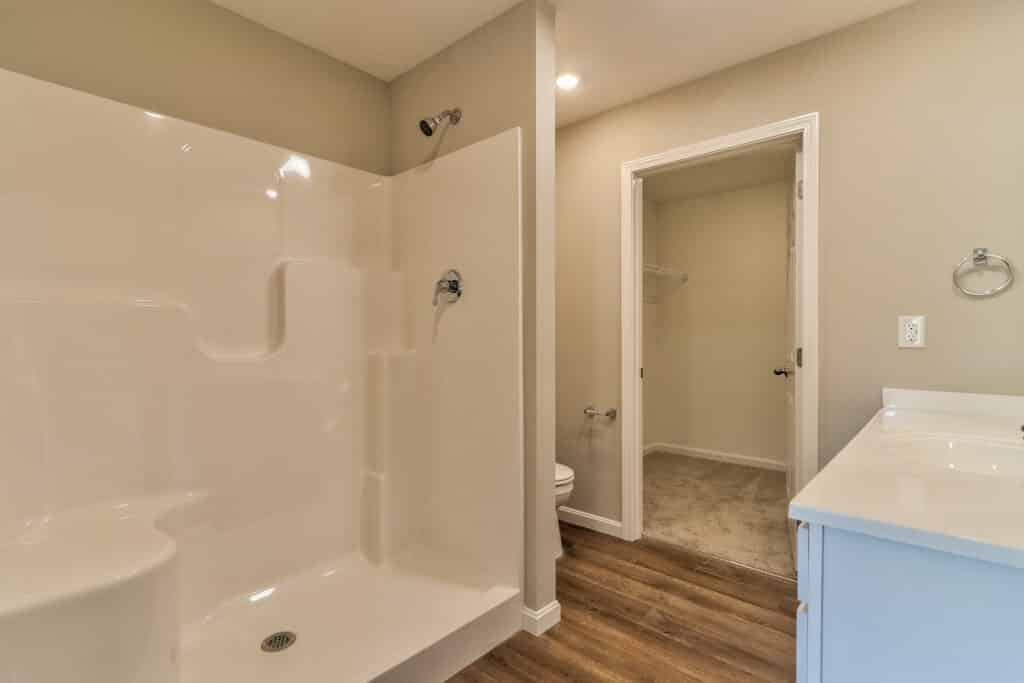 Modern bathroom featuring a spacious shower, clean design, and neutral color palette.