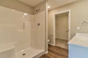 Modern bathroom featuring a spacious shower, clean design, and neutral color palette.