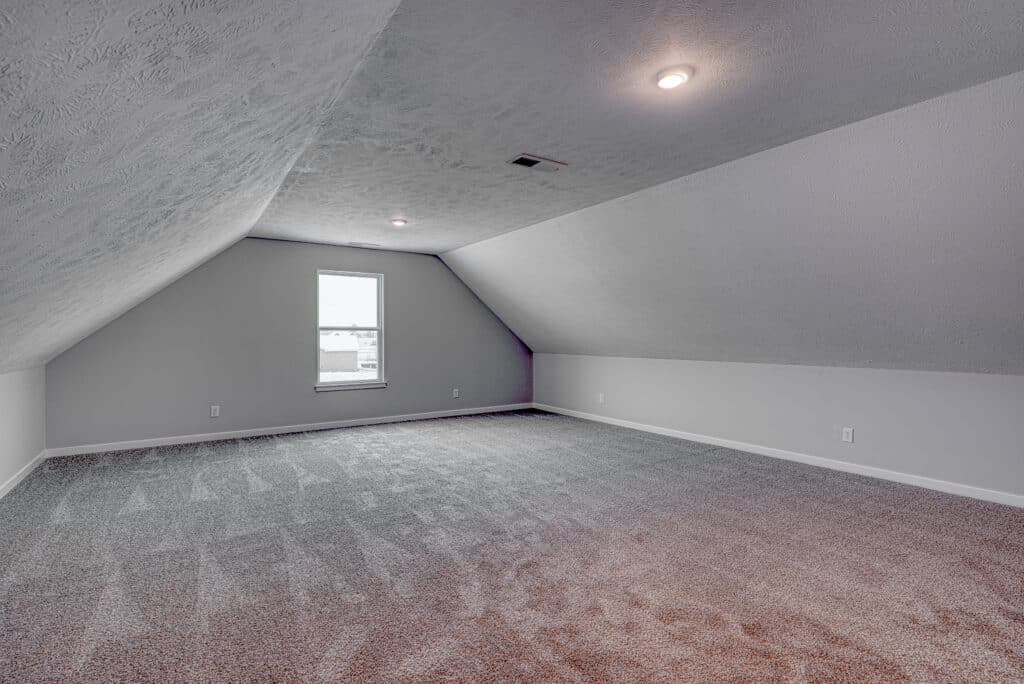 Bright bonus room filled with natural light, perfect for creative projects or storage.
