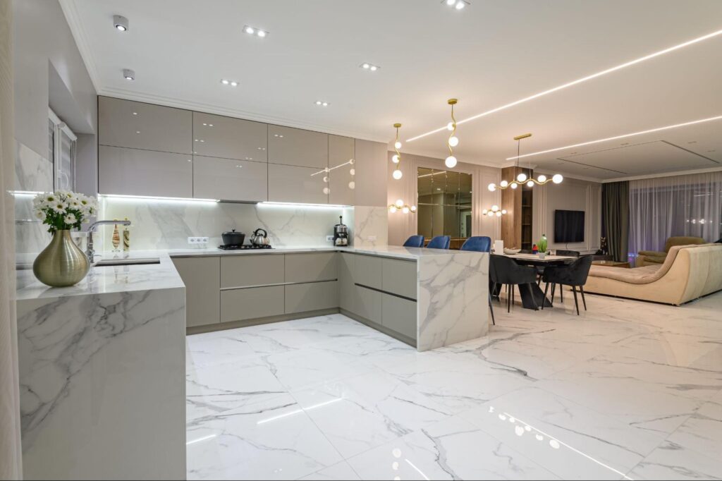 Modern kitchen featuring elegant marble flooring and sleek cabinetry design.