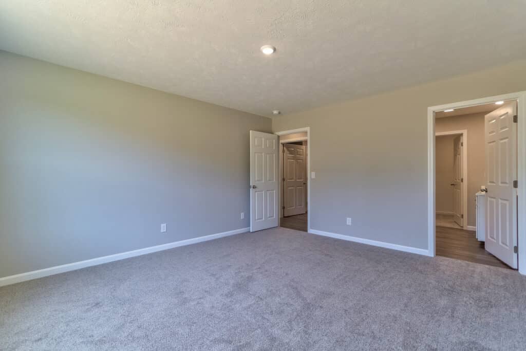 Spacious empty room with open doors, ideal for modern home design or renovation projects.