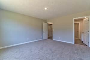Spacious empty room with open doors, ideal for modern home design or renovation projects.