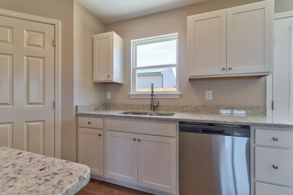Modern kitchen cabinet design featuring white cabinetry and granite countertops.