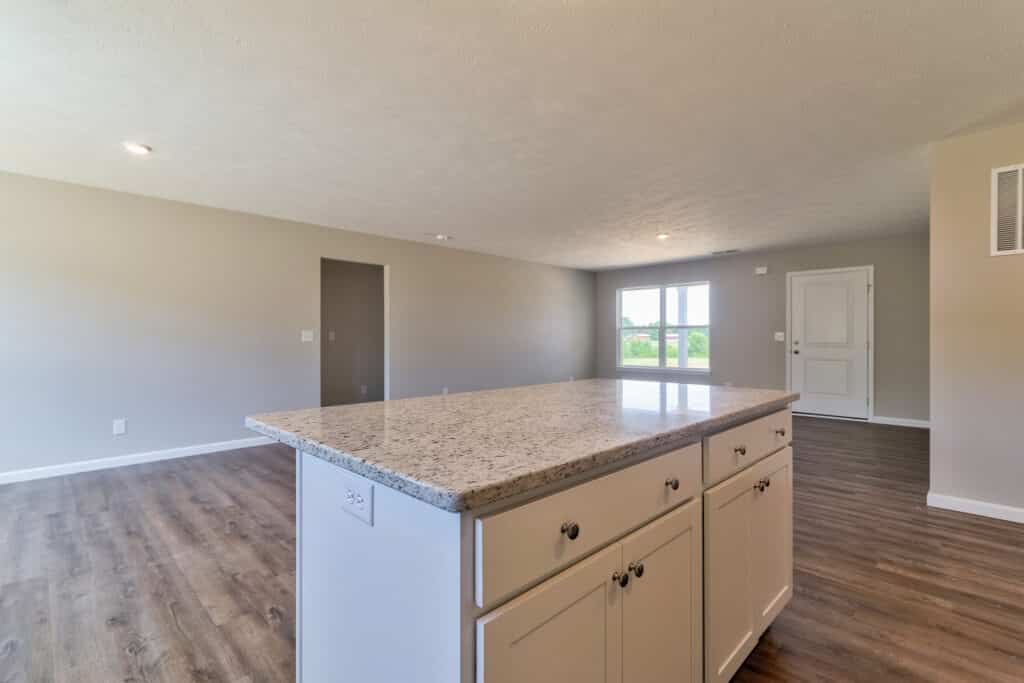Modern kitchen interior featuring a spacious island and sleek design elements.