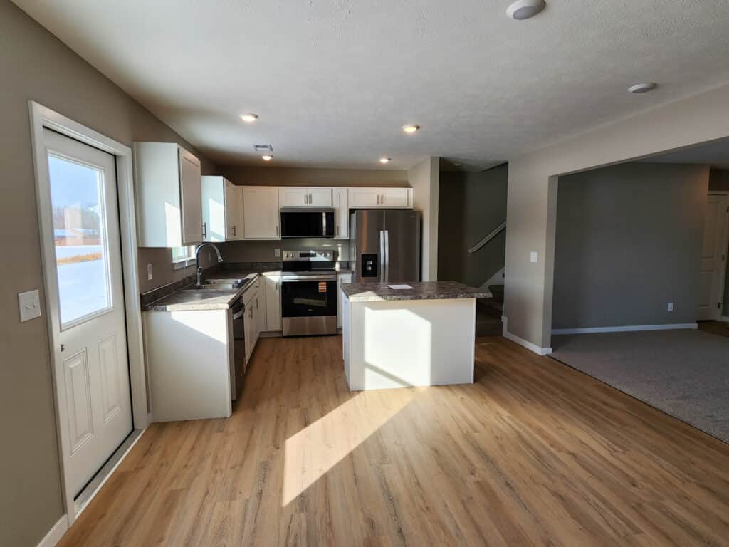 Bright and modern kitchen with sleek cabinets and stainless steel appliances.