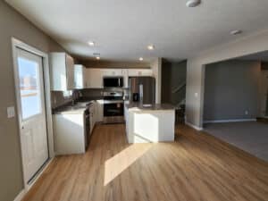 Bright and modern kitchen with sleek cabinets and stainless steel appliances.