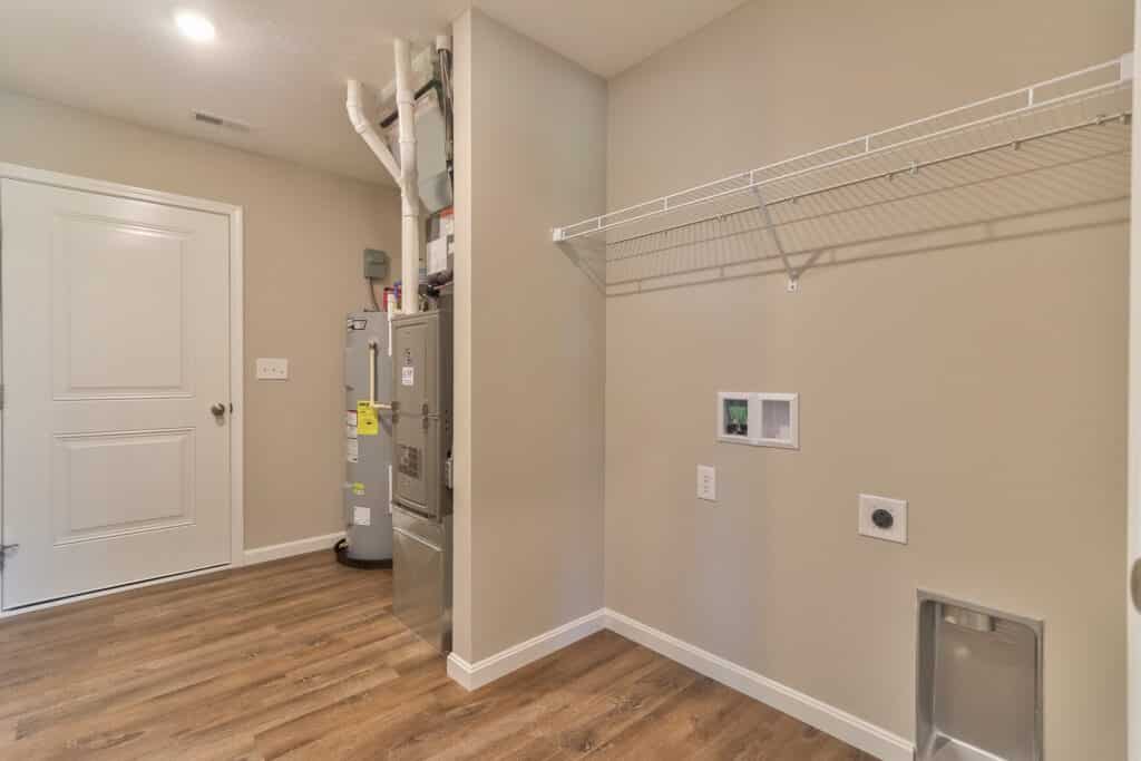 Modern laundry room with utility space and shelves for efficient organization.