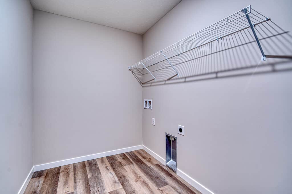 Modern laundry room featuring smart storage and stylish flooring for optimal organization.