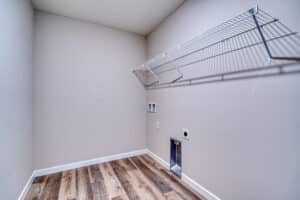Modern laundry room featuring smart storage and stylish flooring for optimal organization.