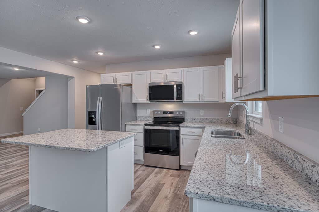 Modern kitchen featuring granite countertops and stainless steel appliances for stylish cooking.