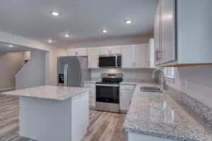 Modern kitchen featuring granite countertops and stainless steel appliances for stylish cooking.