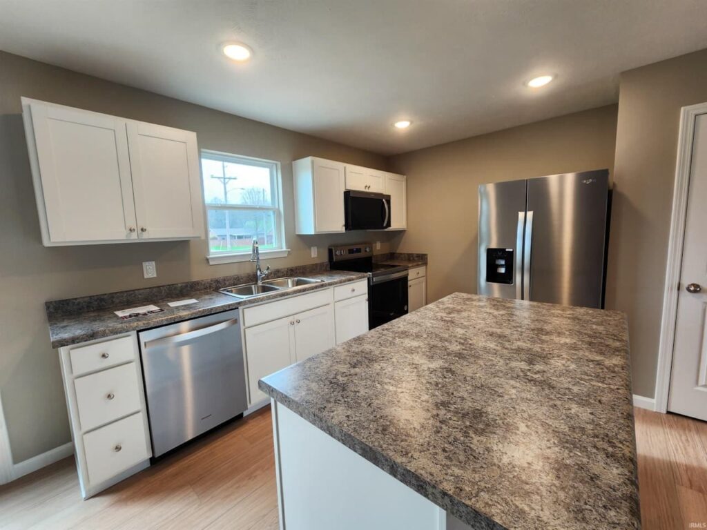 Stylish kitchen featuring sleek appliances and expansive countertops in a modern design.