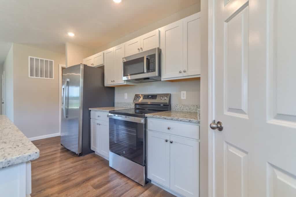 Stylish modern kitchen featuring stainless steel appliances and sleek white cabinetry.