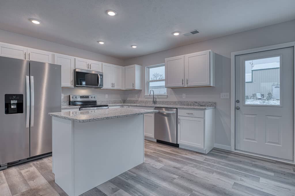 Modern kitchen featuring stainless steel appliances and sleek granite countertops.