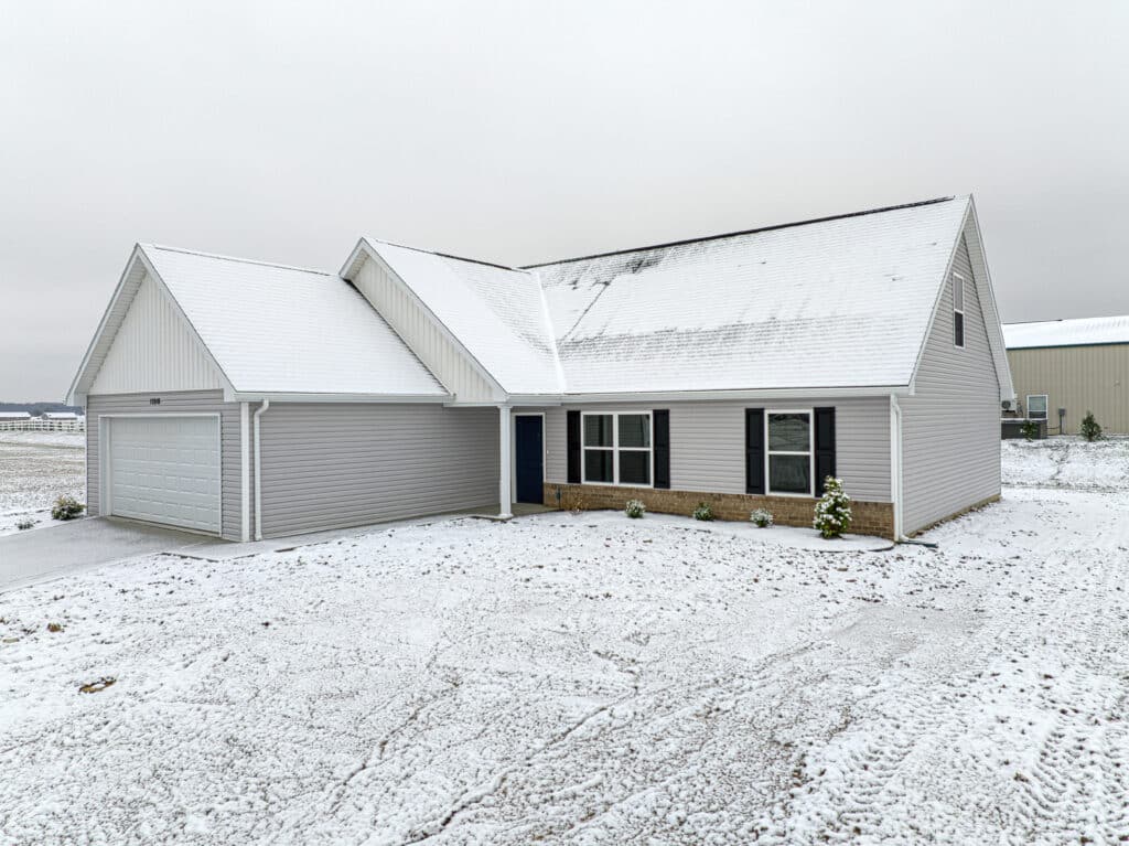 Charming winter home surrounded by fresh snow, ideal for cozy family moments.