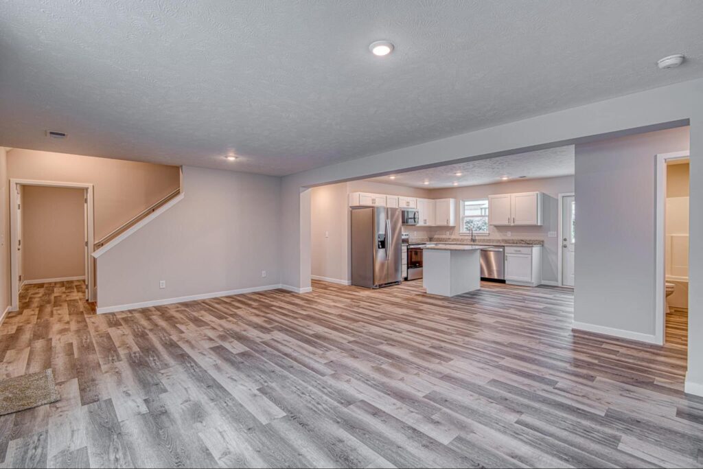 Open concept living and kitchen area featuring sleek wood flooring and modern design.