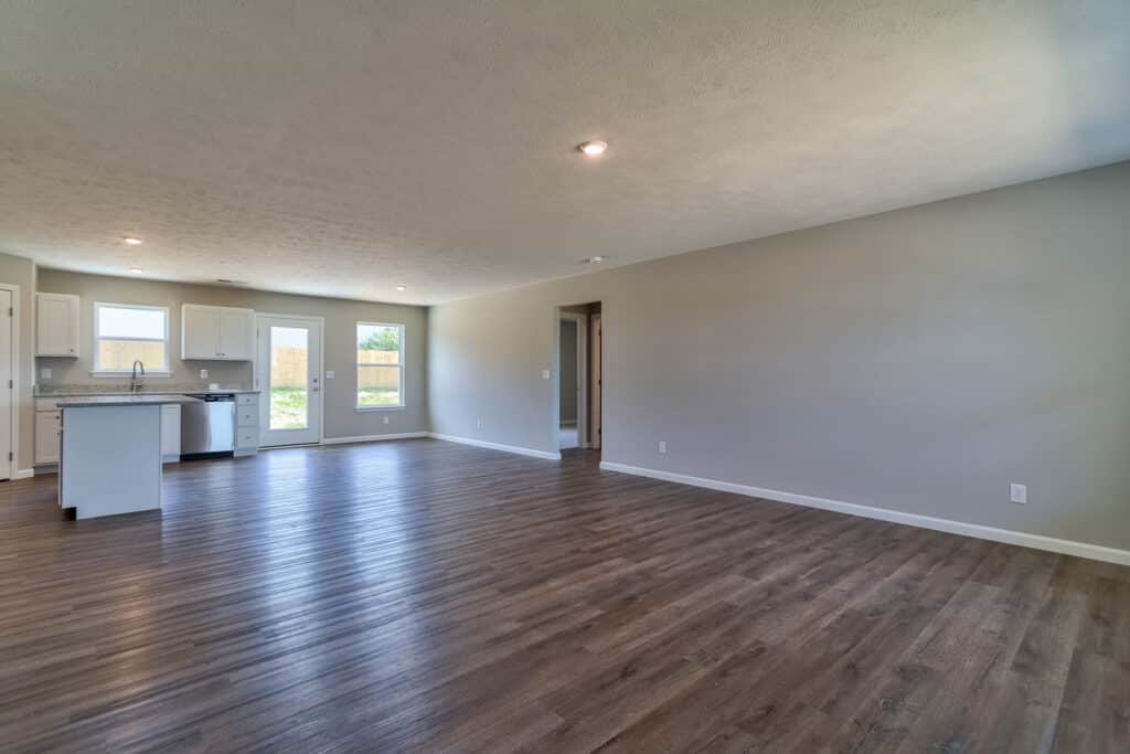 Modern spacious living room with hardwood floors and natural light throughout.