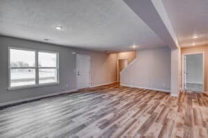 Bright and airy modern living room with natural light and stylish flooring.