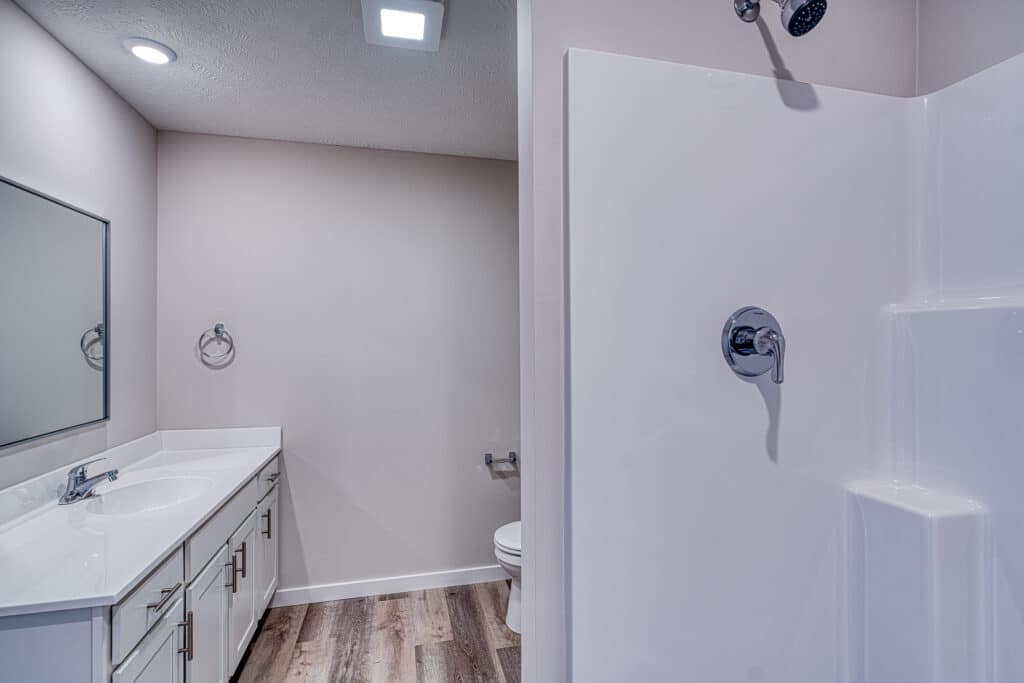 Sleek modern bathroom featuring elegant fixtures and a stylish shower design.