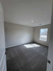 Spacious waterfront villa room with abundant natural light and serene atmosphere.