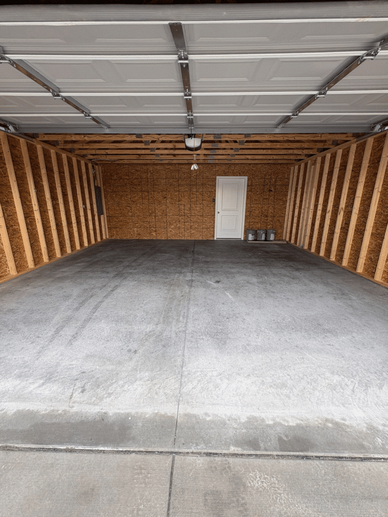 Spacious garage ideal for vehicle storage and organized solutions.