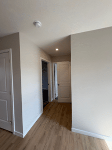 Stylish modern hallway featuring wood floors and contemporary design elements.
