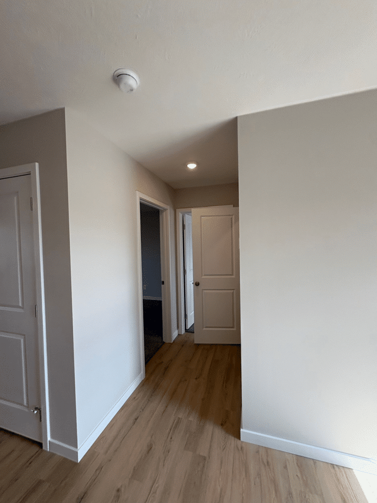 Stylish modern hallway featuring wood floors and contemporary design elements.