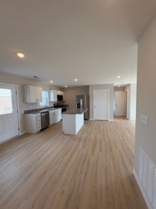 Spacious villa kitchen featuring modern design and elegant wood flooring.