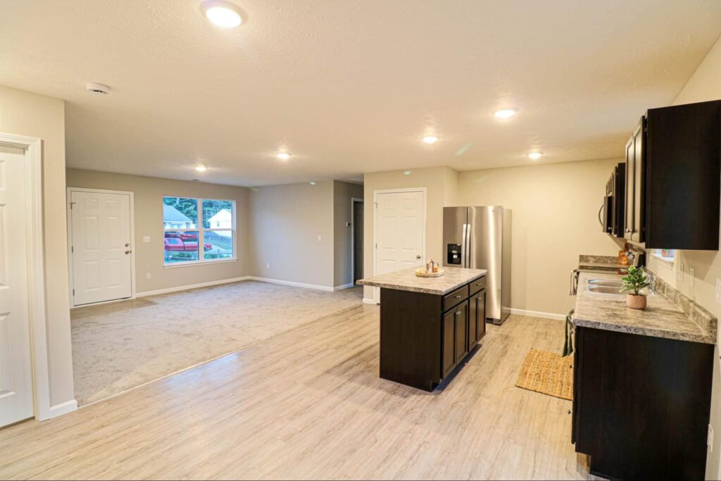 Bright, open kitchen and living area with modern appliances and ample natural light.