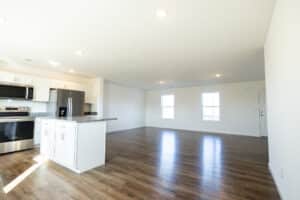 Spacious modern kitchen and living area with sleek appliances and natural light.