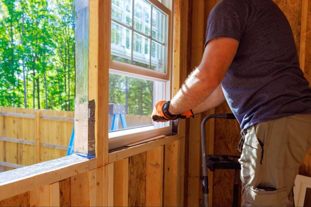 Installing a new window for increased natural light in a home renovation project.