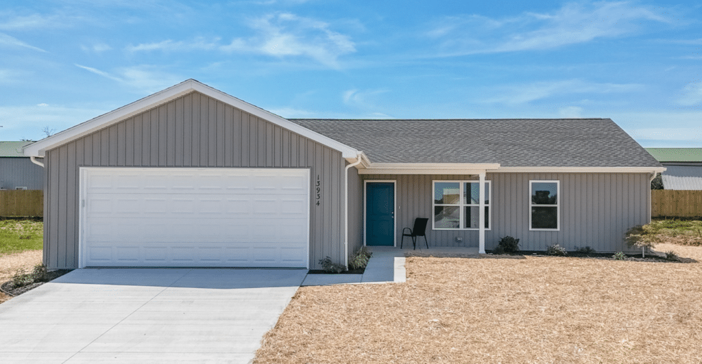 Charming modern home exterior with spacious driveway and sunny blue skies.