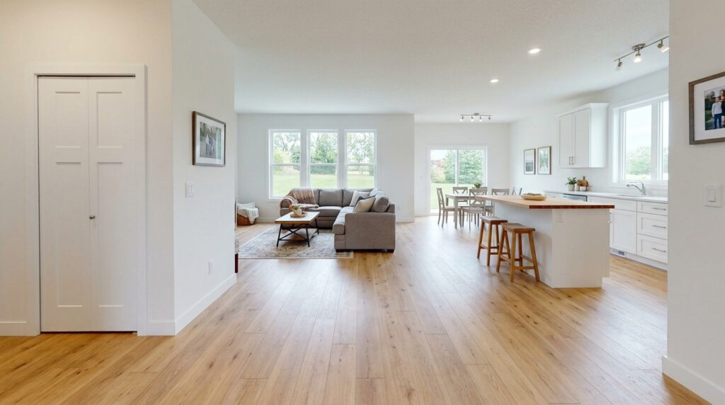 Bright and open modern living room featuring a stylish kitchen and natural light.