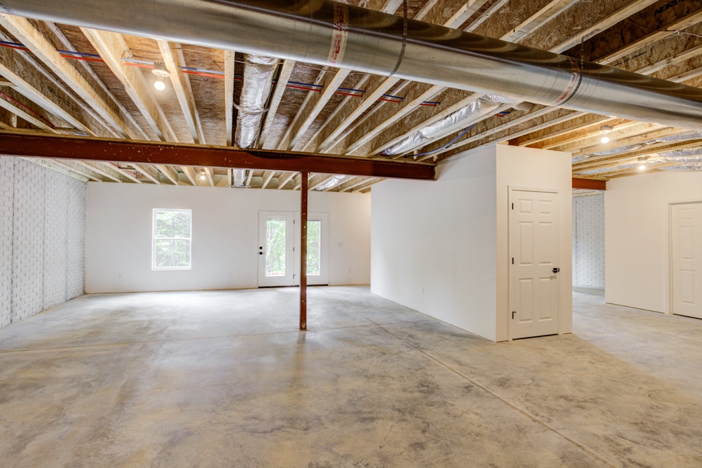 Spacious unfinished basement ready for renovation or customization with natural light and open layout.