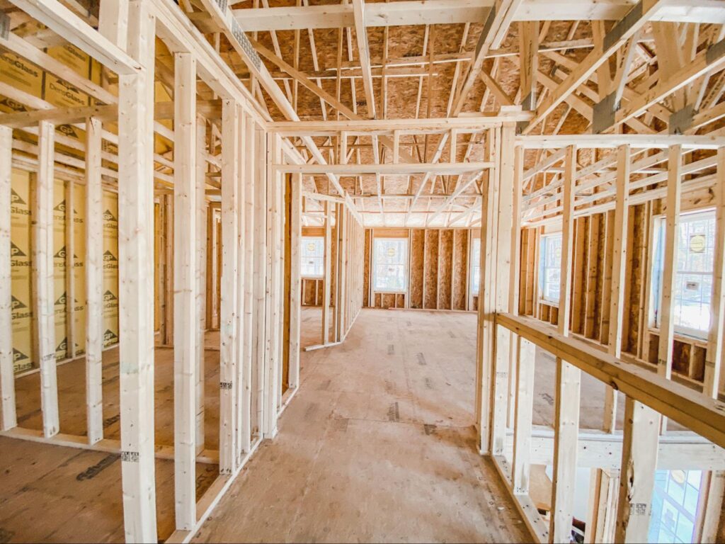 New home construction featuring wooden framing and unfinished interiors in 2023.