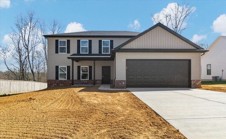 Newly constructed home exterior with garage and landscaped yard.