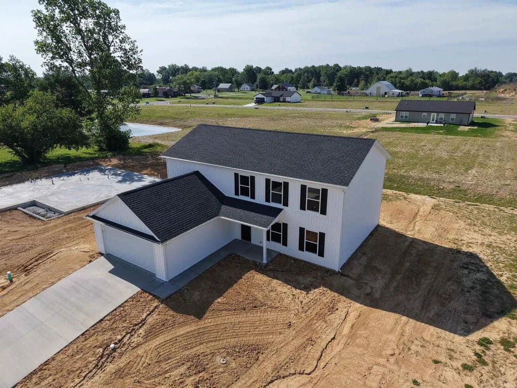 Newly built house on spacious lot with fresh landscaping and modern design.